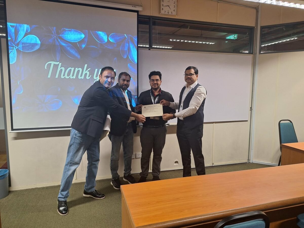 Receiving a certificate of appreciation with the team